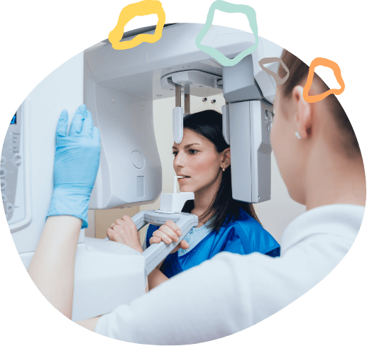 Dental patient receiving a cone beam C T scan of her mouth and jaw