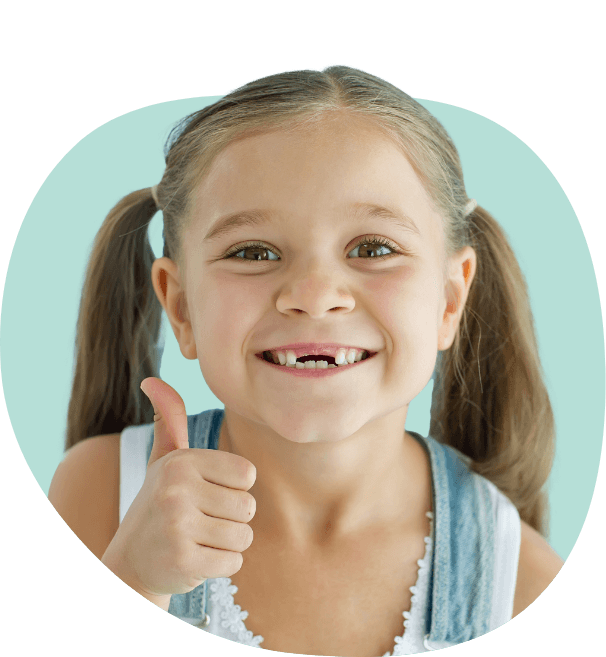 Young girl giving thumbs up and smiling with two teeth missing after tooth extractions