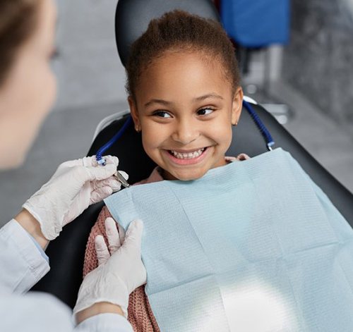 Child smiles at dentist