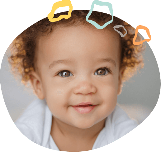 Smiling baby with curly brown hair