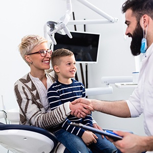 Dentist and mother shaking hands