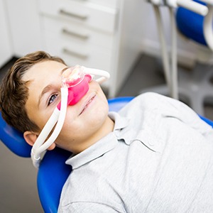 Child smiling while breathing in nitrous oxide