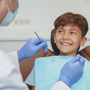 Child smiling at dentist during checkup