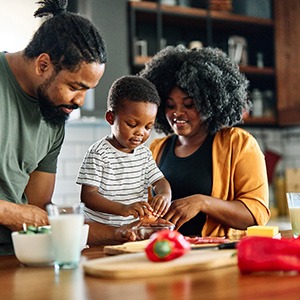 Parent preparing meal together in kitchen