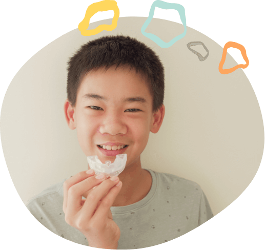 Boy holding a clear mouthguard