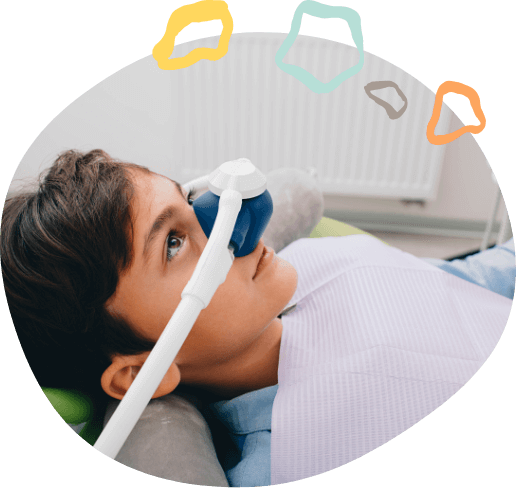 Boy in dental chair wearing nose mask for nitrous oxide