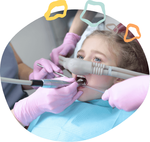 Girl receiving dental treatment while wearing nitrous oxide mask