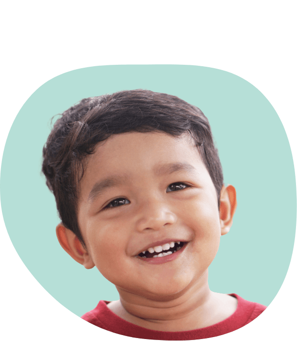 Young boy with black hair smiling after visiting dentist for toddlers in South Portland and Auburn