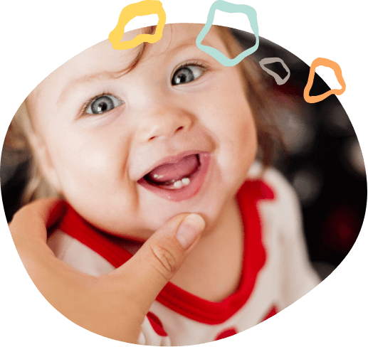 Toddler grinning with only two lower teeth