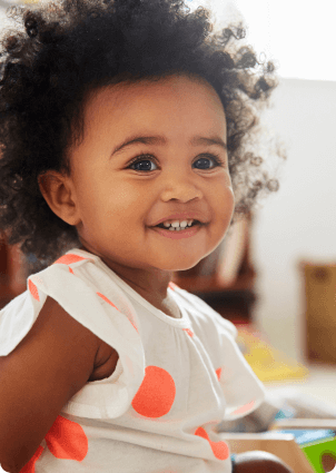 Smiling baby sitting on floor