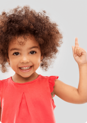 Smiling toddler holding up their index finger